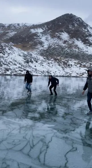 Artvinli gençler buz tutan Karagöl’de taş atıp test ettiler, sonra eğlendiler
